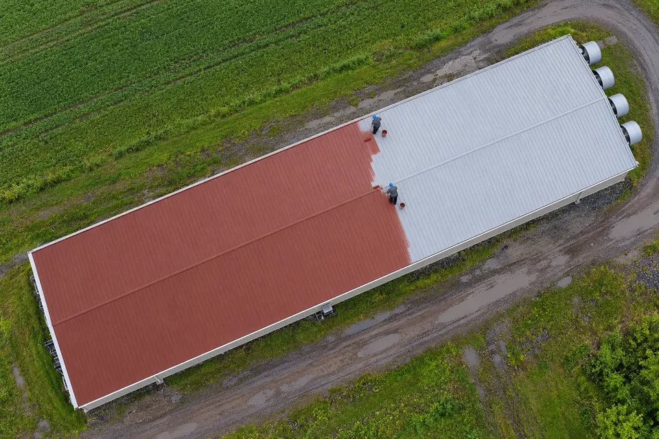 Aerial view of a pitched metal roof on a large shop and barn building
